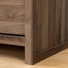 a close up view of a wooden dresser with drawers and wood flooring on it