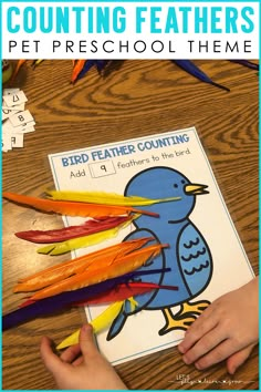 a child's hand is holding feathers in front of a book with the title counting feathers