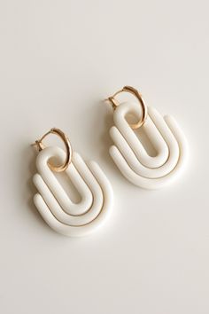 Art Deco collection with a vibrant color palette, bold graphics, and expressive geometric textures that give your style a modern touch. SIZE AND MATERIAL *Earrings are made with 18k gold-plated hoops. *Size: 40 x 25mm ( 1.57 x 0.98 in) *Lightweight: 11g a pair *Porcelain glazed from one side The lightweight design makes ceramic earrings ideal for everyday wear. Porcelain earrings are designed and handmade in our Riga studio. No two pairs are identical. That's the beauty of handcrafted jewelry! All Rozenthal jewelry is beautifully packaged in a gift box. SHIPPING AND HANDLING Note that shipping and handling will take up to 3 days from the day of your purchase. All Rozenthal jewelry is beautifully packaged in a gift box. FREE SHIPPING Latvia: 1 - 3 Business days Europe: 7 - 12 Business days Bold White Jewelry For Gift, Bold White Jewelry For Gifts, Modern White Hoop Jewelry, Modern White Geometric Earrings, Modern Single White Earring, Modern White Earrings With Ear Wire, Bold Geometric Earrings With Bold Design, Bold Geometric Designed Earrings, Modern Small Hoop White Earrings