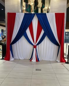 a red, white and blue stage set up for an event in a shopping center