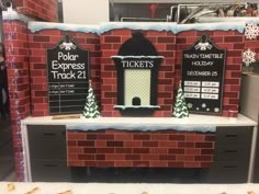 a display in a store with brick walls and christmas decorations on the front, along with holiday themed signs