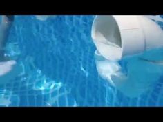 an inflatable tube floating on top of a swimming pool next to a man