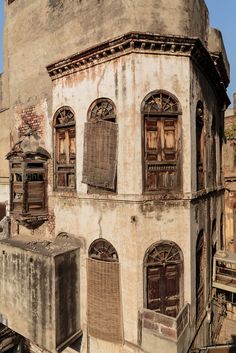 an old building with lots of windows and shutters