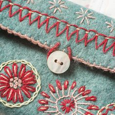 a close up of a button on a piece of fabric with flowers and circles around it