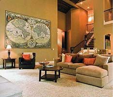 a living room filled with furniture and a large map hanging on the wall above it