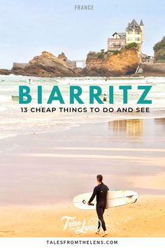 a man holding a surfboard while standing on top of a sandy beach next to the ocean