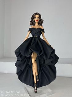 a barbie doll wearing a black dress and high heels