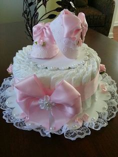 a white cake with pink bows on top