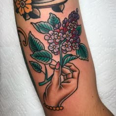 a person holding a flower in their left hand with the word love on it and an arrow above them