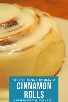 a cinnamon roll on a white plate with the words amish friendship bread cinnamon rolls