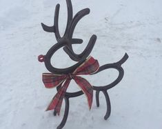 an antlers with bows are standing in the snow