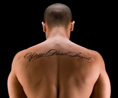 a man with a tattoo on his back