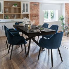 a dining room table with blue chairs around it