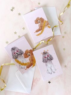 three cards with poodles on them sitting next to some gold ribbons and confetti