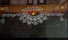 a wooden frame decorated with white and red flowers on top of a black marble floor