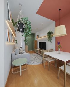 a living room filled with furniture and a flat screen tv on top of a wooden floor