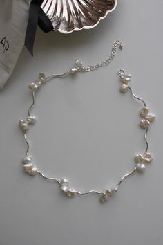 These freshwater pearl necklace made for an elegant addition to any outfit. Classic jewelry vibe combined with the fashion-forward trend. Comfortable for daily wear, suitable for every occasion. Materials: * 925 Sterling Silver  * Freshwater pearls Dimensions: * Chain Length : 36 cm * Extension chain: 5 cm * Sold As One Piece Usage: Keep away from perfume and chemicals in the products you buy. Package: All our jewellery come in a nice jewellery box, in which it is comfortable to store and pleasant to gift Silver And Pearl Necklace, Delicate Silver Baroque Pearl Jewelry, Adjustable Silver Choker Pearl Necklace, Silver Baroque Pearl Necklace Gift, Adjustable Silver Baroque Pearl Necklace, Baroque Pearl Choker With Pearl Chain For Gift, Pearl Silver Necklace, Pearl Diy, Pearl Necklace Choker