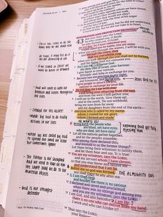 an open bible with colorful text on it