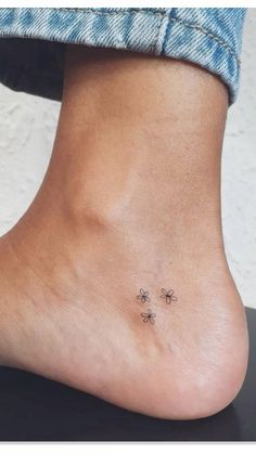 a woman's foot with three small stars on it