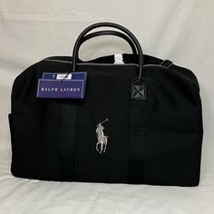 Polo Ralph Lauren Black With White Logo Travel Duffel Leather Straps And High Quality, Thick Canvas Material Brand New In Plastic With Tags Great For Any Occasion!!!! Black Leather Bag With Embroidered Logo, Classic Bags With Embroidered Logo For Daily Use, Classic Rectangular Bags With Embroidered Logo, Black Rectangular Bag With Embroidered Logo, Ralph Lauren Travel Bags With Handles, Elegant Black Ralph Lauren Bags, Ralph Lauren Travel Bag With Dust Bag, Ralph Lauren Travel Bags With Leather Trim, Black Duffel Bag