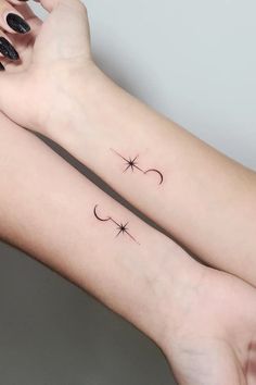 two women with matching tattoos on their arms, one has a star and the other has a crescent