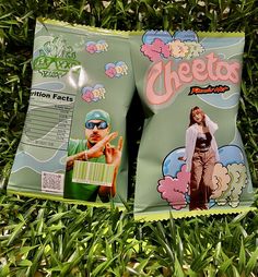 two bags of cheetos sitting on top of green grass next to each other