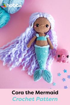 a crocheted mermaid doll next to a ball of yarn with the caption, cora the mermaid crochet pattern