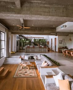 a living room filled with furniture and lots of windows