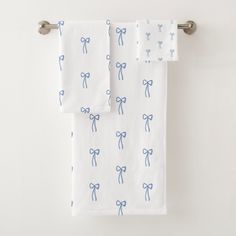 two white towels with blue bows on them