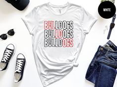 Bulldog Mascot Shirt, It's a Great Day To Be a Bulldog, Bulldogs Shirt, School Spirit Shirt, Bulldog School Mascot Shirt, Custom Bulldog 🚚 SHIPPING  &  PRODUCTION  TIME      ▶ Items typically shipped same day if color/size are in stock (feel free to inquire prior)      ▶ If not in stock, shipping/production time is typically 1-5 business days      ▶ Please contact us if you are in a rush! 🎆 BACK  UPGRADE      ▶ If you would like to add text to the back, please go to the listing below and add to cart      ▶ https://www.etsy.com/listing/1222039886 👕 MATERIALS      ▶ Heather Colors are cotton/polyester blend (super comfy and soft)      ▶ Bella Canvas brand shirts - Size/color chart(s) available in photos      ▶ Soft and high-quality fabric, pre-shrunk, tapered shoulder-shoulder; Side seame Bulldog Volleyball, Bulldog Football, Bulldogs Shirt, Mascot Shirt, Bulldog Mascot, Bulldogs Football, School Spirit Shirts, Bulldog Shirt, Spirit Shirts