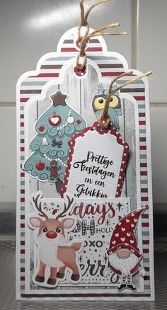 a christmas card with reindeer, snowman and trees on the tag that says merry