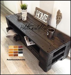 a coffee table made out of pallet wood with the words home written on it