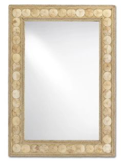 a mirror that is made out of wood and has circles on the border around it