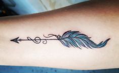 a tattoo with an arrow on the back of its arm and two feathers attached to it