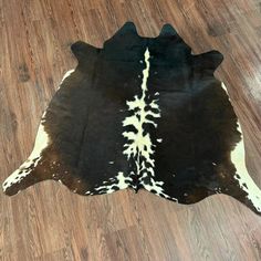 a black and white cowhide rug on the floor