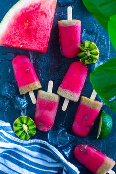 watermelon popsicles with lime slices and mints on a blue tablecloth