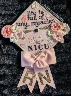 a graduation cap decorated with flowers and ribbon