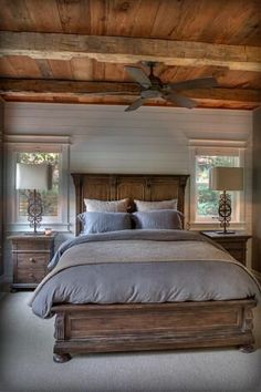 a bedroom with a bed, dresser and ceiling fan in the middle of the room