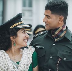 a man and woman in uniform standing next to each other