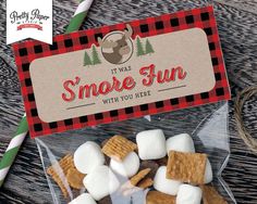 there are marshmallows in the plastic bag on the table with a sign that says, it was s'more fun with you here