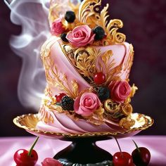 a fancy cake with pink frosting and roses on top, surrounded by cherries