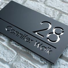 a black metal sign with the number 28 on it