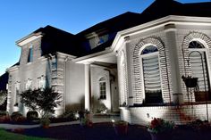 Image of home lit-up with NiteLites outdoor lighting. Residential Lighting, Custom Lighting