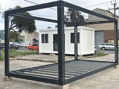 a black and white portable home sitting in the middle of a parking lot