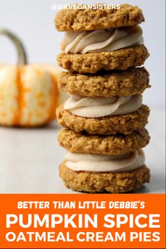 three cookies stacked on top of each other with frosting and pumpkins in the background