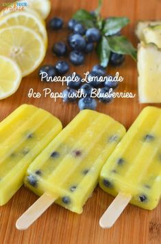 lemonade ice pops with blueberries on a cutting board