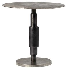 a round metal table with an iron base