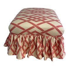 a red and white ottoman with ruffled edges