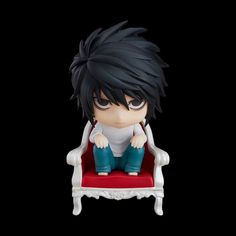 an anime figurine is sitting on a red chair with black hair and blue pants