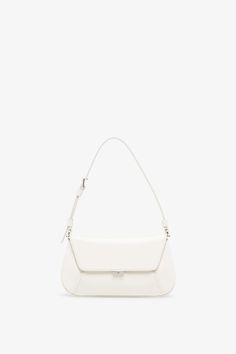 White leather bag from Amina Muaddi. The Ami mini bag is made of calf leather with silver finish hardware, a magnetic closure along with an inside mirror frame. It features an internal flat pocket and is complete with an adjustable strap.Measurements: L21 x H12 x W4 cmMade in Italy Timeless White Flap Bag With Detachable Strap, Timeless White Satchel For Everyday Use, Timeless White Leather Satchel, Timeless White Satchel For Everyday, Timeless White Everyday Satchel, Everyday White Timeless Satchel, Timeless White Double Handle Shoulder Bag, White Leather Top Handle Baguette Bag, White Leather Baguette Bag For Everyday Use